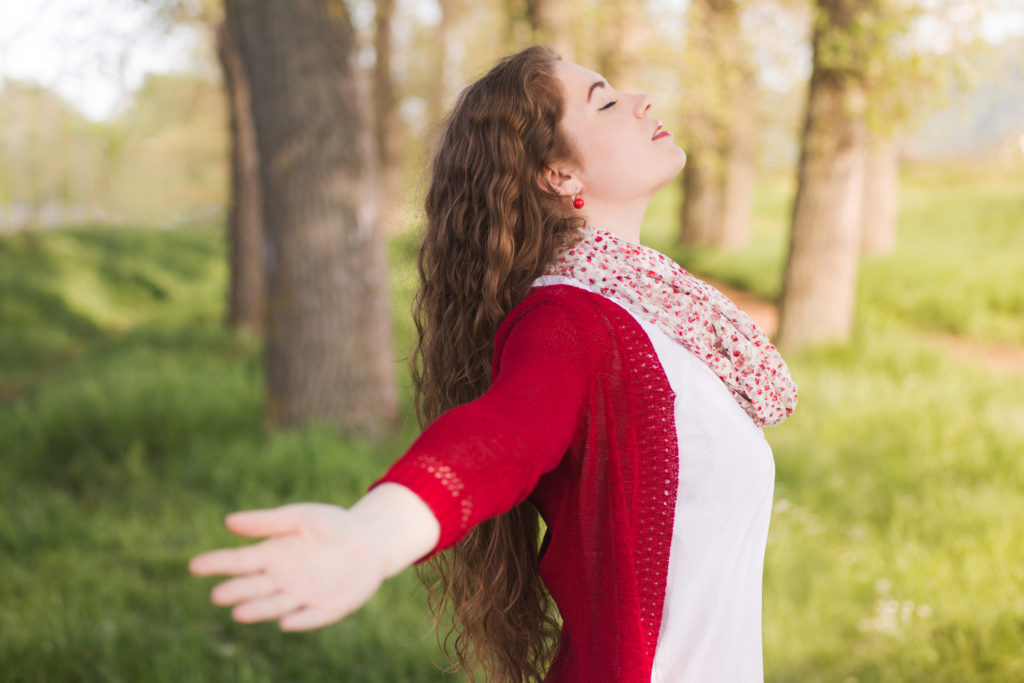 A young woman using a breathing technique to manage anxiety